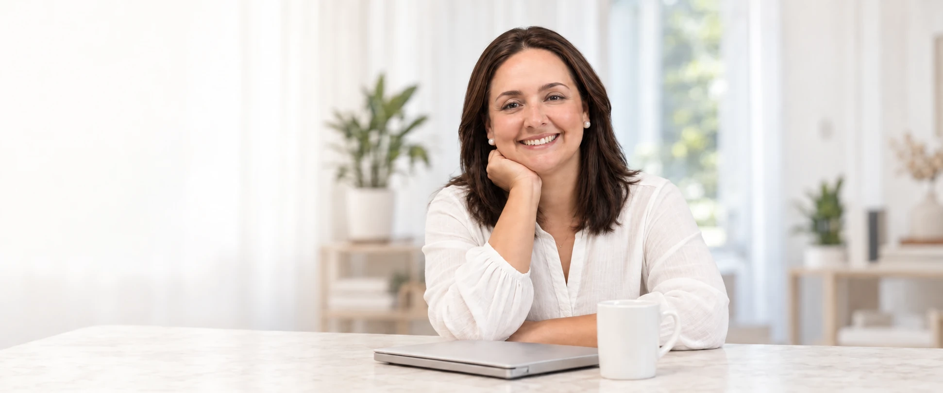 AI-assisted editorial portrait of Alejandra Merino in a bright home office, wearing a white blouse and resting her chin on her hand